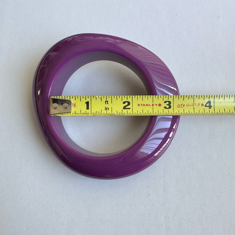 Lavender resin bangle with an organic shape and glossy finish.